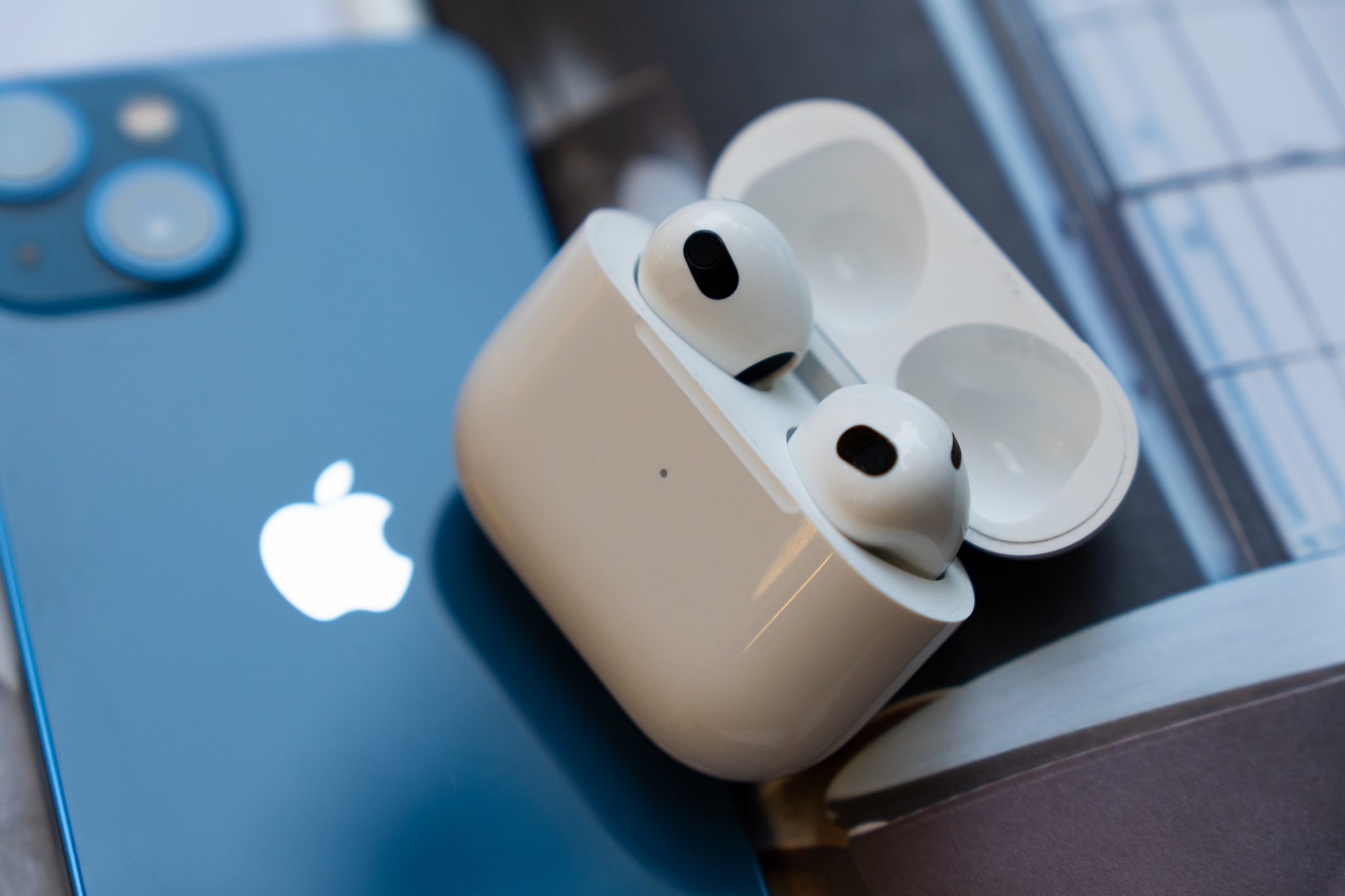 AirPods 3 with charging case and an iPhone