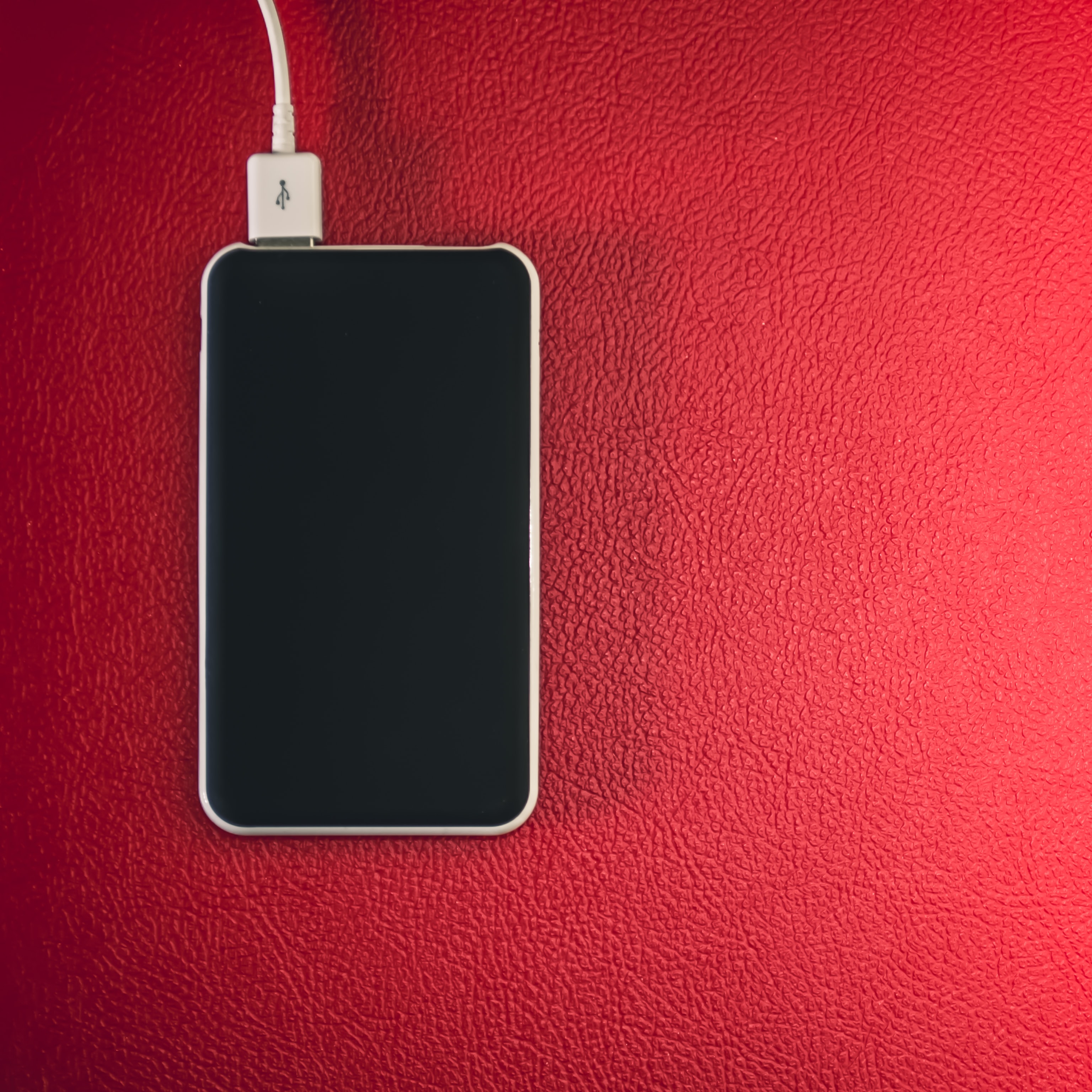 Phone charging with a red background