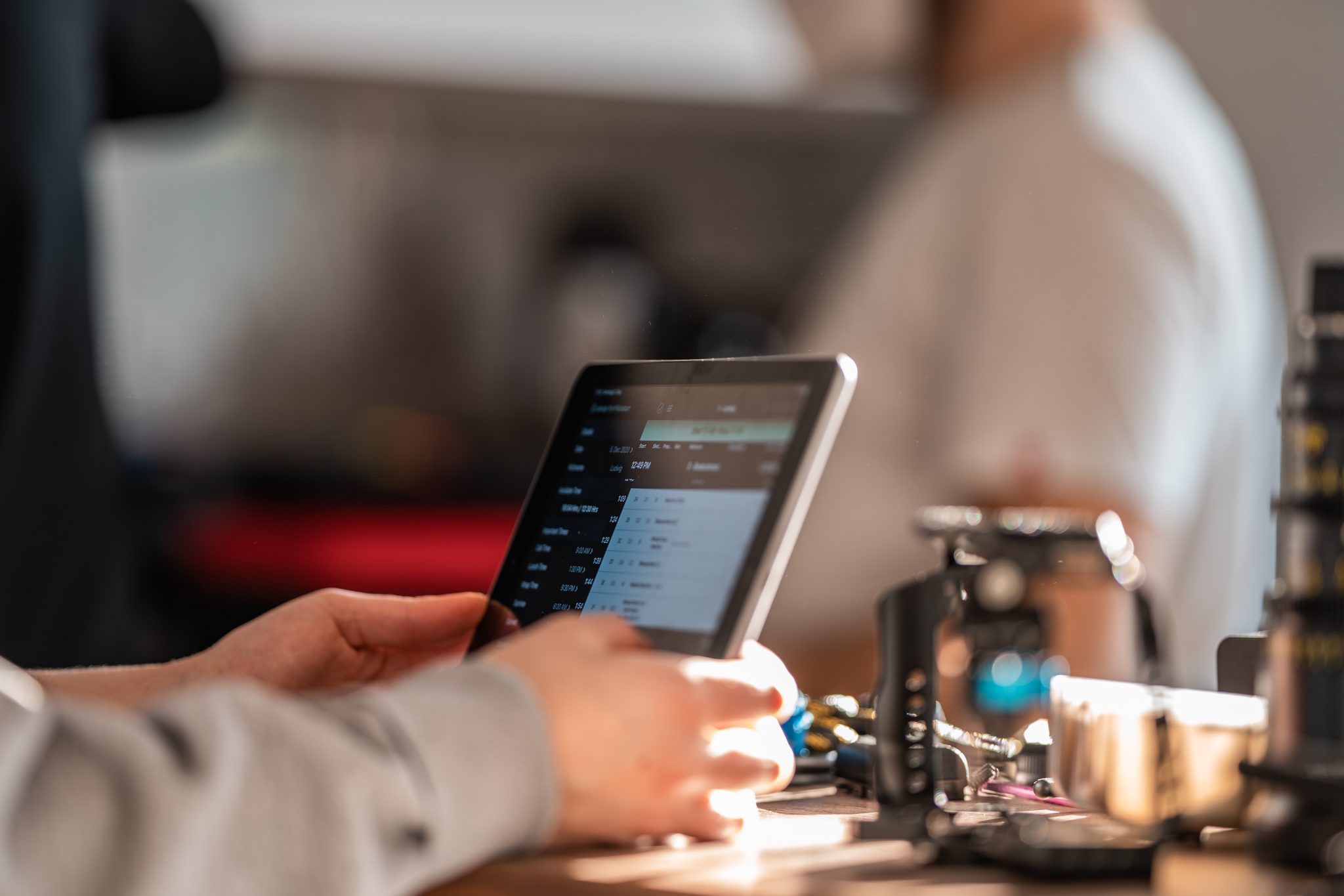 Person using standing iPad on a desk