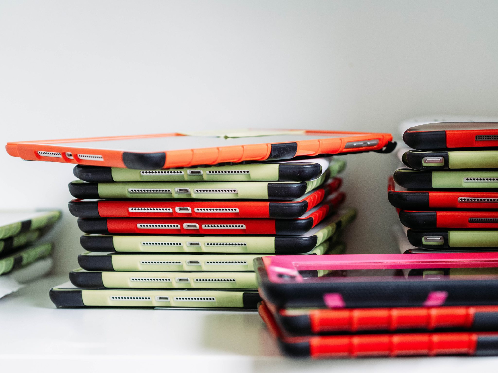 Stacked iPads of different colors.
