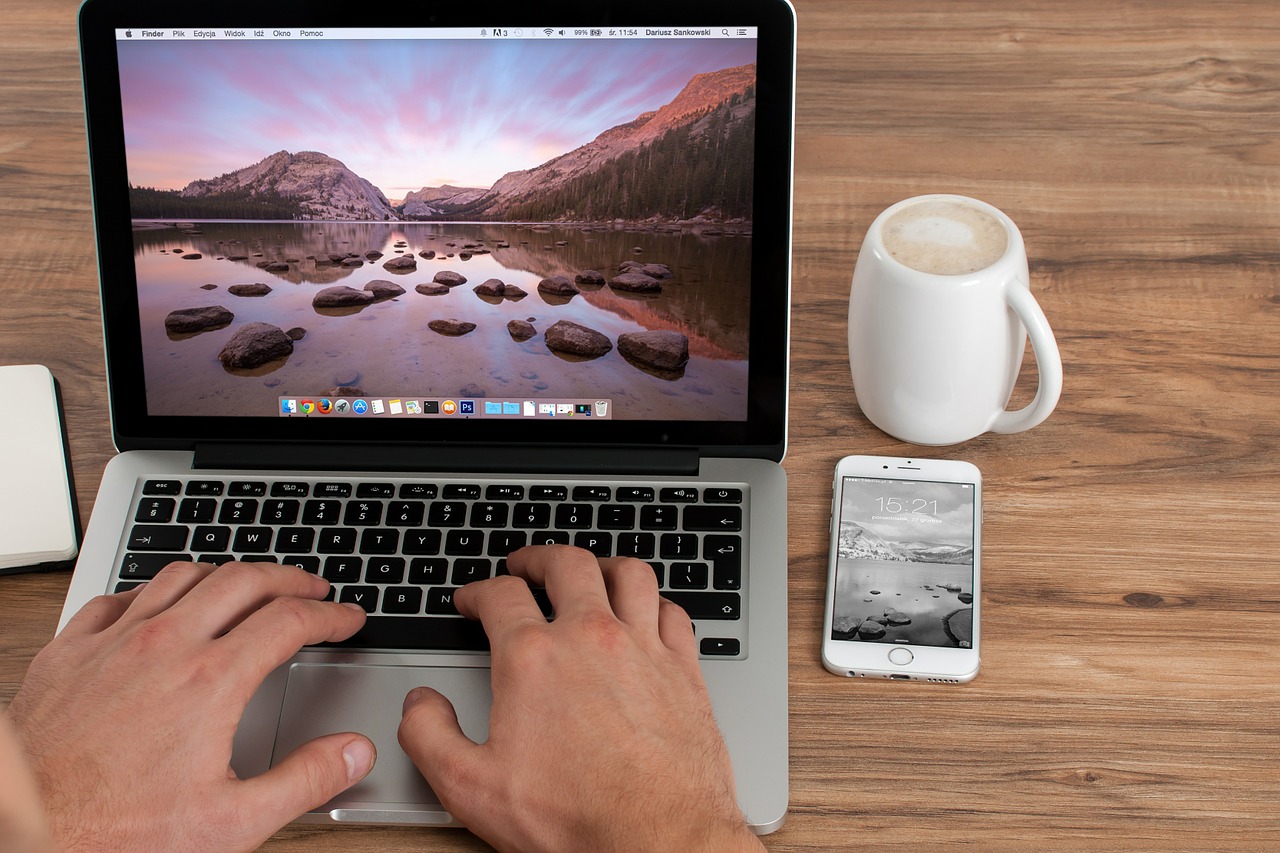 MacBook and iPhone on a wooden table